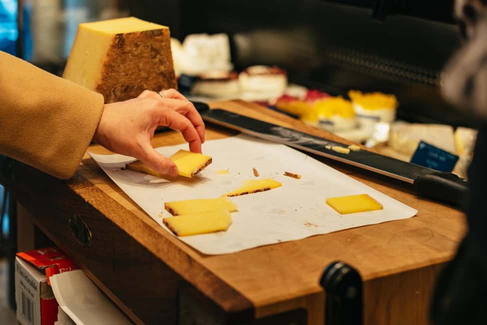 Paris: Gourmet Food Tour with Over 10 Tastings and Wine - Street-market wandering and a brioche sweet finish near Rue des Petits Carreaux