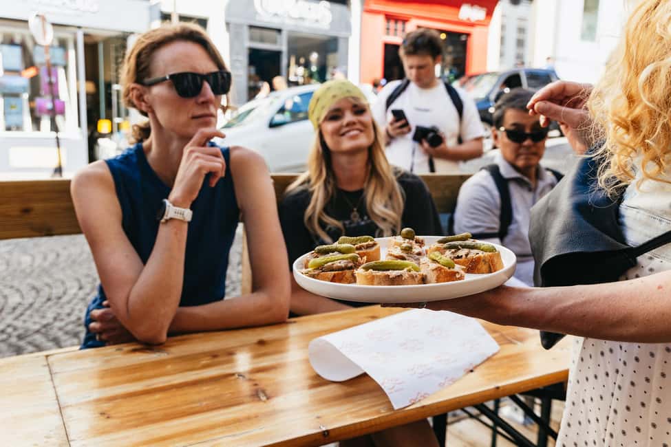 Paris: Montmartre Cheese, Wine & Pastry Guided Walking Tour - Place du Tertre and Moulin Rouge: iconic views with context