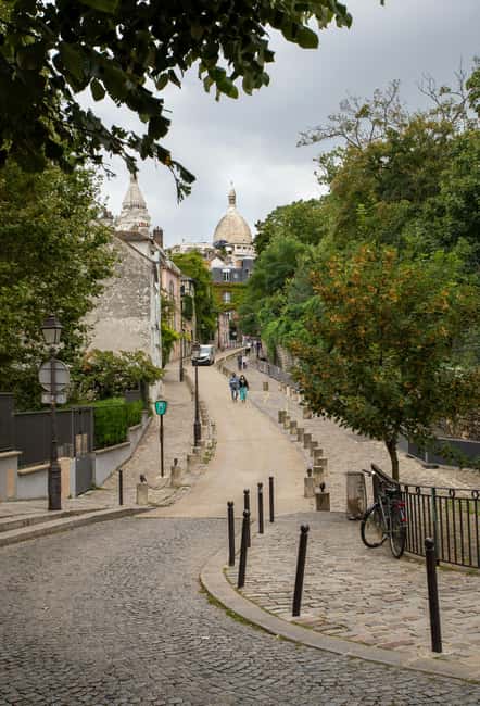 Paris: Montmartre hidden gems walking Tour with Local Guide - Moulin de la Galette: mills to music to Montmartre magic